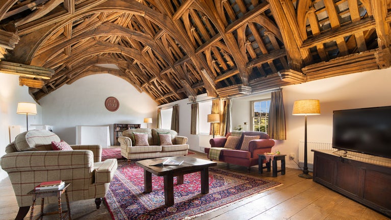 The great hall with original oak hammer beam ceiling at West Challacombe Manor, Devon